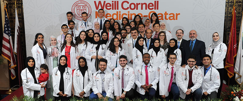 Dr. Javaid Sheikh, dean of WCM-Q, faculty members, and the Class of 2021 with their white coats and stethoscopes.