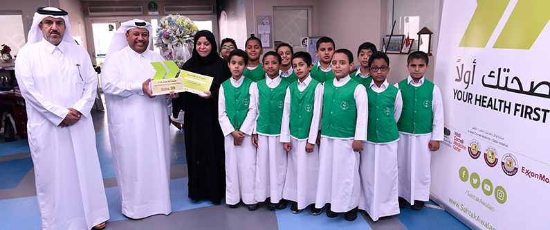 (Left to right) Hassan Al-Mohamedi, Director of Public Relations and Communications at the Ministry of Education and Higher Education, with Khalifa Al-Derham, Director of School Affairs at the Ministry, Fawziya Abdullah Al-Kuwari, the principal of Jawaan Bin Jassim Primary School for Boys, and some of the winning students.