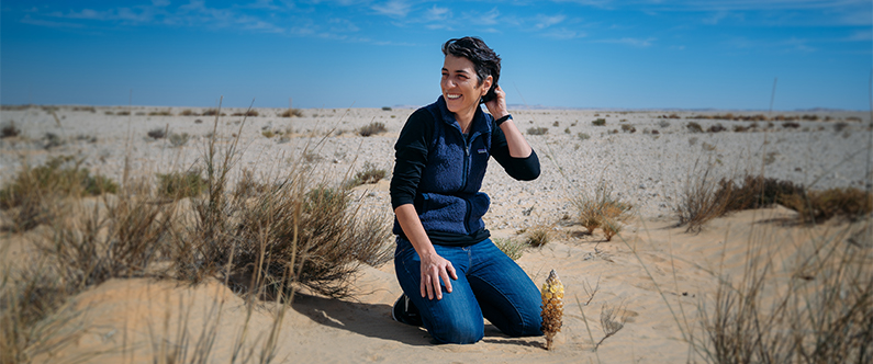 Dr. Chatziefthimiou, pictured with a desert hyacinth, said cyanobacteria are found in almost all environments and are a vital part of desert ecology.