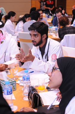 Med 3 student Adham Musthak discusses patient safety with fellow students.