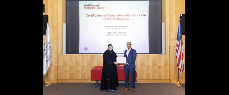 Fatma Wael Al-Emadi, from Al Maha Academy for Girls, receiving her honors certificate from Dr. Rachid Bendriss.