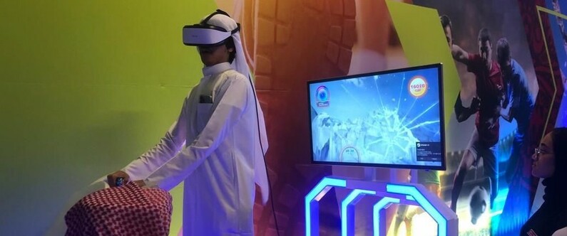 A participant enjoying an immersive Sahtak Awalan VR game at Msheireb Downtown Doha’s World Cup activation zone.