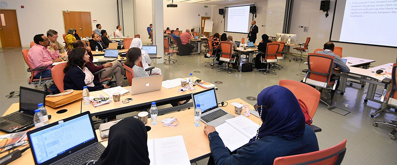 Participants at the WCM-Q biostatistics for healthcare professionals workshop listen to a session led by Dr. Ziyad Mahfoud, WCM-Q associate professor of healthcare policy and research.