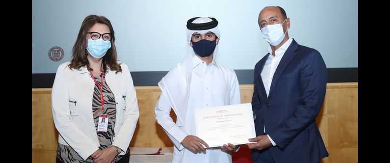 High school student Abdulla Adel AlMutawa of Gulf English School receives his certificate of participation for completing WCM-Q’s Qatar Aspiring Doctors Program from Dr. Rachid Bendriss and Ms. Noha Saleh.  