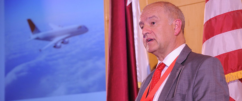 Dr. John Roberts, group medical director for Qatar Airways, addresses the symposium.