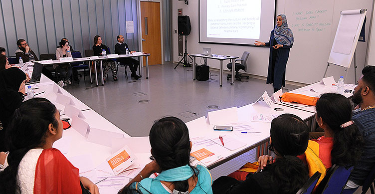 Dr. Sohaila Cheema, director of the Institute for Population Health, leads a workshop.