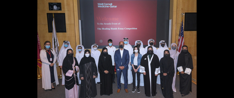 Dr. Rachid Bendriss, center, and Noha Saleh, far left, with participants of the WCM-Q Healing Hands essay competition. 