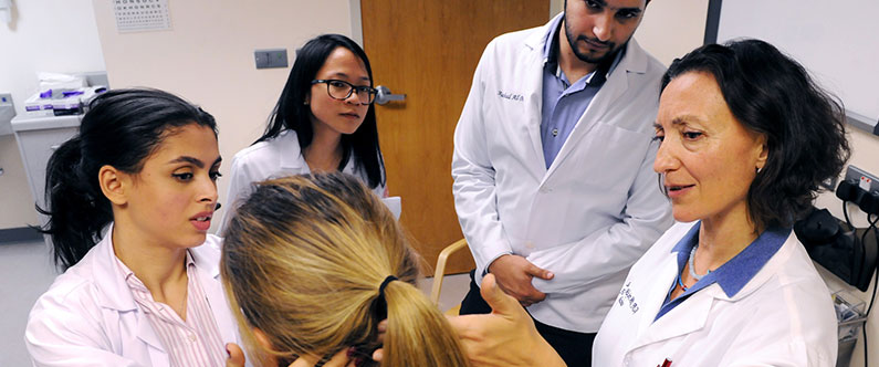 Dr. Stella Major, right, teaching WCM-Q students essential physicianship skills in the college’s  state-of-the-art Clinical Skills Center.