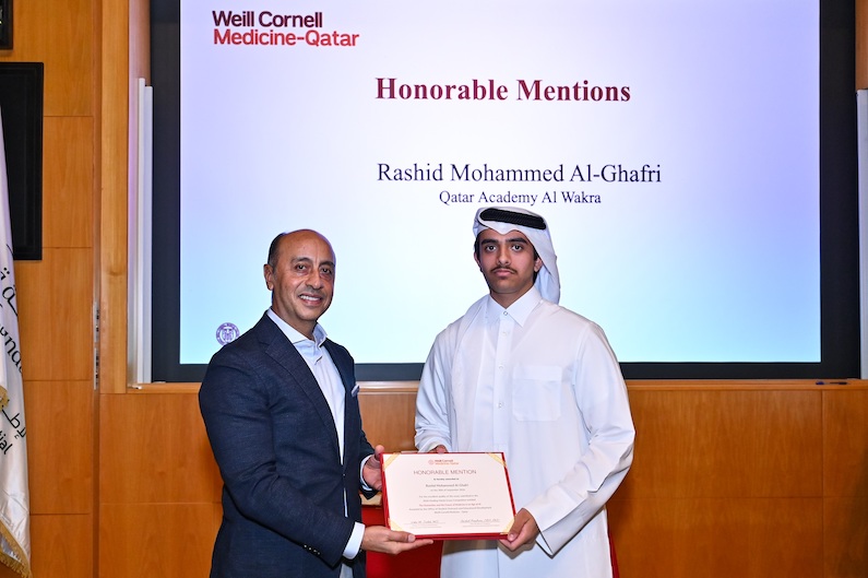 Dr. Rachid Bendriss with high school student Rashid Mohammed Al-Ghafri, who received an honorable mention in the WCM-Q Healing Hands essay contest.
