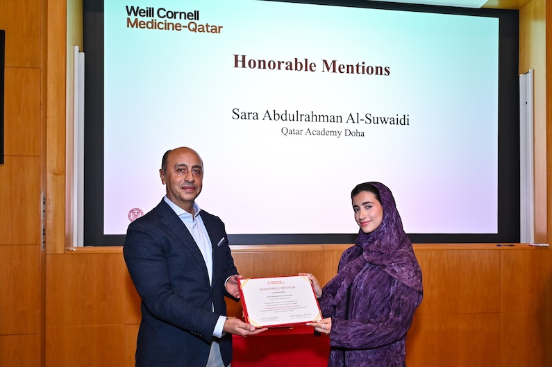 Dr. Rachid Bendriss with high school student Sara Abdulrahman Al-Suwaidi, who received an honorable mention in the WCM-Q Healing Hands essay contest.