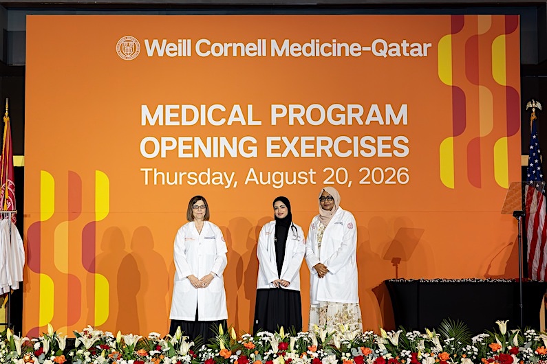 Medical student Amna Abdulrahman Al-Baker receiving her white coat and stethoscope from Dr. Thurayya Arayssi and Dr. Mai Mahmoud. 