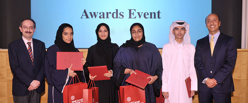 The winners of the Weill Cornell Medicine-Qatar Healing Hands essay competition 2016 with Dr. Marco Ameduri, left, and Dr. Rachid Bendriss, right.