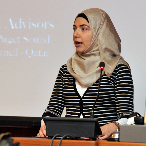 At a public reading event to showcase student involvement in a social research project, first-year medical student Marwa Saleh discusses the life of 'Govinda,' a migrant worker in Doha.
