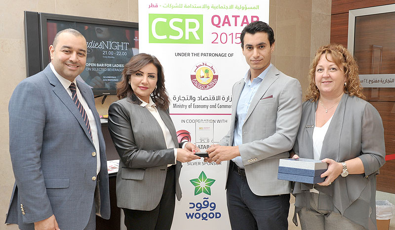 Chief Communications Officer Nesreen Al-Rifai (second left) receives the CSR Best Community Development Award for the Sahtak Awalan - Your Health First campaign, with Marketing Communication Manager Ahmed Eissa (left).