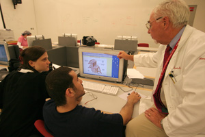 Associate professor of neurology and neuroscience and course co-director for the second year pre-medical Brain and Mind course, Dr. Leopold J. Streletz (right), helps students Amila Husic and Osama Al Saied understand a clinical problem resulting from damage to the brain pathway.