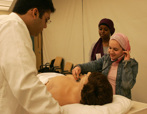 Heart of the matter: Medical student Ibrahim Sultan guides students from Amna Bint Wahab Independent Secondary School for Girls as they listen to Harvey’s heartbeat.