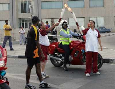 A proud moment: Manisha Deb Roy (right) accepts the 2006 Asian Games torch from her father. 