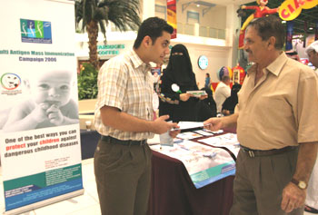 Pre-medical student Salman Al Jerdi (Class of 2012, left) was among those students distributing leaflets about immunization at Landmark shopping mall in November.