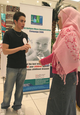 Youssef Francis (Class of 2012) gets behind the National Health Authority’s Multi-Antigen Mass Immunization Campaign, as he takes a question from an interested community member.