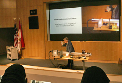 The demonstration of experiments using everyday materials was part of workshop one. Here, professor of physics Dr. Roger Hinrichs uses a light bulb to show optical activity.