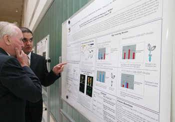 First-year medical student Qusai Saleh explains his research to Associate Dean for Pre-medical Education Dr. David Robertshaw.