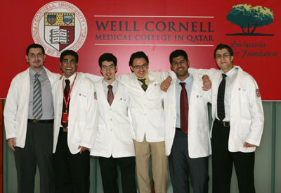 A few students together in an informal group, caption:  Gathering of good friends: class members celebrate after the event. 