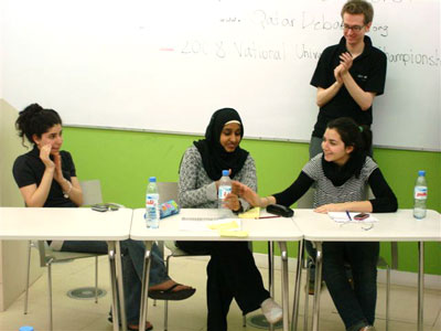 Qatar National Universities' Debate Champions: Nadine Saad, Rahima Sanya and Marwa Saleh with a QatarDebate coach