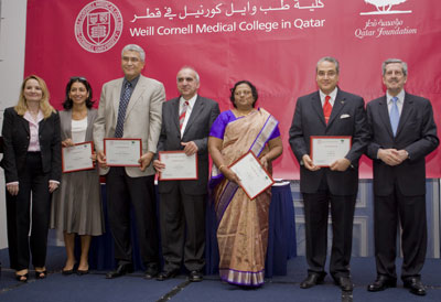 A "bittersweet" moment: Dr. Nounou Taleghani arranges the academic hood for Kunali Dalal.